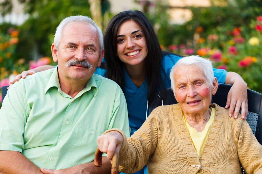 In home caregiver in Missoula posing with family and a patient for a photo